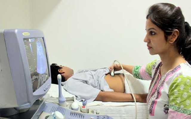 A Women checking ultrasonography for a patient.