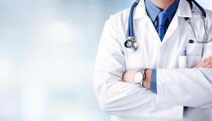 A Professional Doctor Standing and Holding his Stethescope