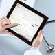 A Person operating a medical software in his tab.