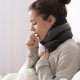 A Sick Woman Coughing While Sitting In A Couch On Her Home.