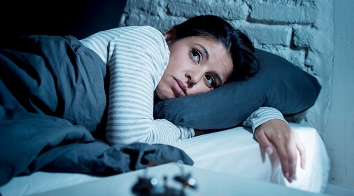 A Woman Lying In Bed Late At Night Trying To Sleep Suffering Insomnia Sleeping Disorder.