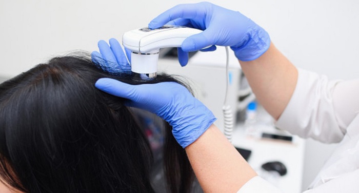 A Dermatologist Checking One Woman's Hair.