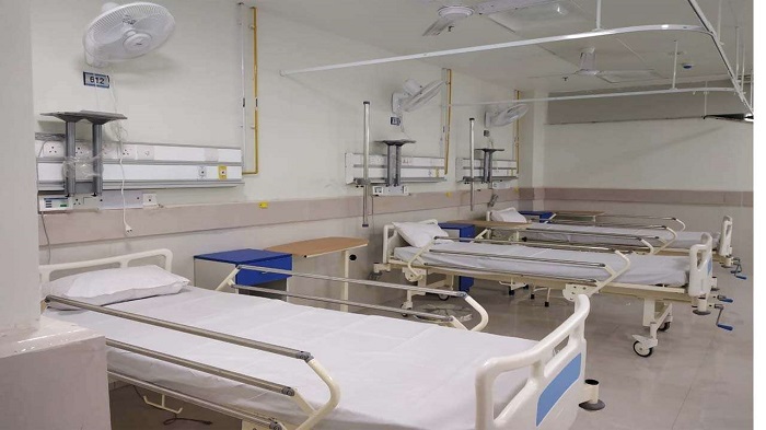 The inside of a hospital with beds and basic facilities.