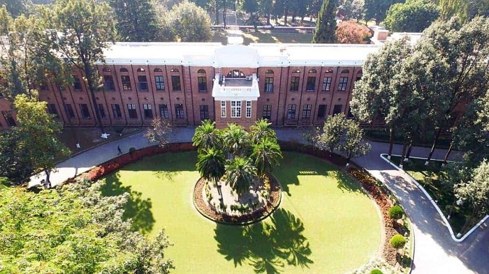 An aerial view of a school building with its surroundings.